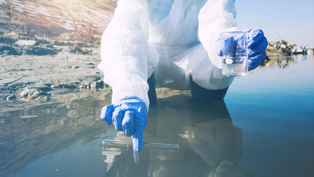 Ecologist taking samples of water for testing